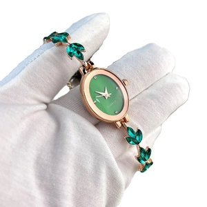 Elegant rose gold oval quartz watch with green leaf-shaped gemstone bracelet for women