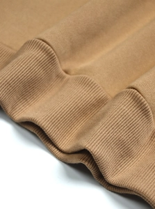 Macro shot of khaki ribbed cuffs and cotton knit fabric texture on this vintage sweatshirt