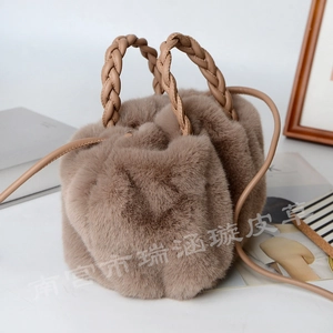Close-up of khaki faux fur drawstring bag with woven handle on a white aesthetic background