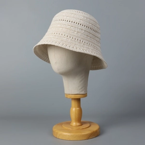 Minimalist beige breathable knit bucket hat for women on display stand