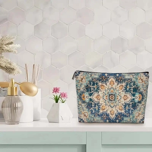 Bohemian patterned makeup bag with Persian carpet design and zipper closure on white desk