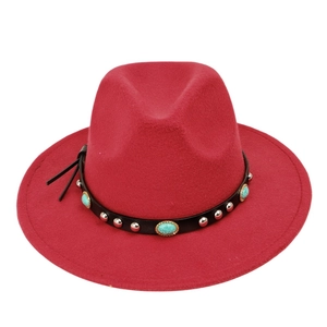 Detail of dark red fedora hat with black leather band and turquoise stone embellishments