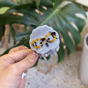 Detail of cute puppy hair claw clip made of tortoiseshell acetate with glasses motif