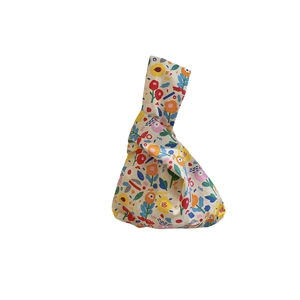 Floral cotton canvas wrist bag with abstract colorful patterns and knot handle design