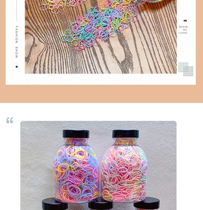 Macro shot of colorful macaron hair elastics in transparent jars on a wooden surface