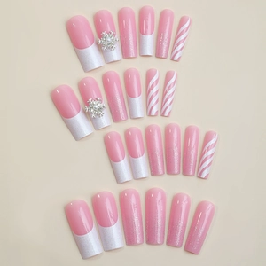 Pink and white Christmas press on nails with snowflake charms and glitter in long coffin shape