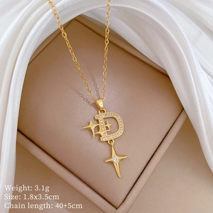 Close-up of gold D-letter and star pendant with rhinestones and size specifications