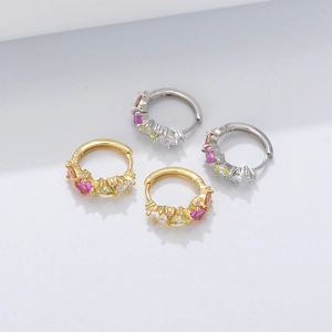 Detail of s925 silver huggie earrings with colorful zircons in gold and silver finish