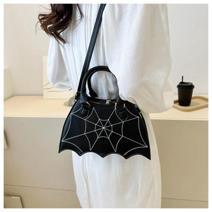 Detail of gothic black saddle bag featuring white spiderweb stitching and bat wing edges