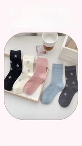 Five pairs of star-patterned crew socks in black, beige, pink, blue, and grey