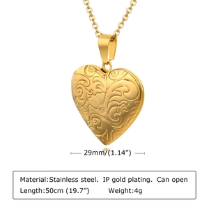 Detail showing an openable gold heart locket pendant on a stainless steel chain