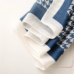 Detail of blue and white houndstooth pattern on soft breathable fabric scarf