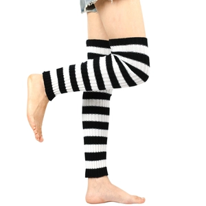 Close-up of black and white striped knitted leg warmers in over-the-knee style