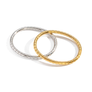 Set of gold and silver bamboo style stainless steel bracelets on white background