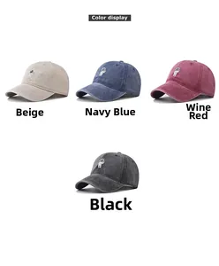 Detailed color display of four washed cotton baseball caps with astronaut embroidery