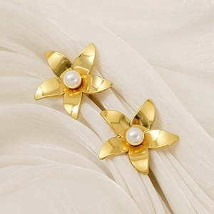 18k gold plated flower earrings with white pearls and textured petals on white silk background