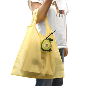 Yellow translucent reusable shopping bag with cute plush avocado keychain attachment