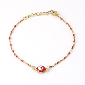 Gold stainless steel bracelet with red evil eye charm and bead accents on white background