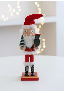Detailed close-up of a 27cm wooden Nutcracker Santa Claus with plush decor and tree