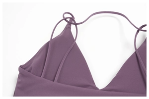 Close-up of thin crossed shoulder straps on a purple high-elastic yoga sports top