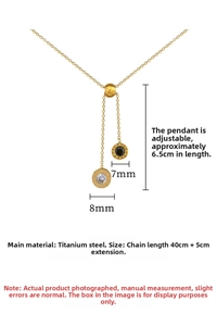 Detailed view of titanium steel necklace with Roman numerals, zircon, and black charms
