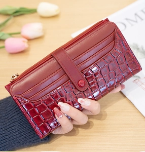 Detailed close-up of wine red crocodile pattern long wallet with multiple card slots