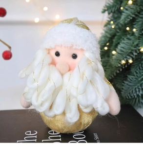 Close-up of Santa plush doll with gold glitter base and soft lamb wool hat on festive background