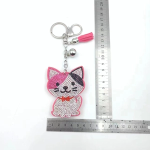 Pink and white cat rhinestone keychain with pink tassel and silver bell measuring 13cm