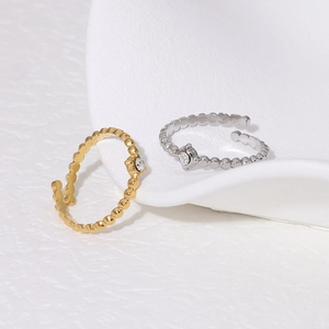 Macro shot of 18K gold and silver plated bead rings with sparkling crystal accents