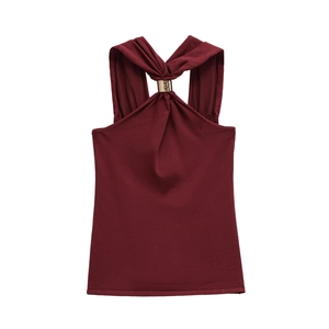 Close-up of wine red halter top featuring fine knit texture and gold metal buckle detail