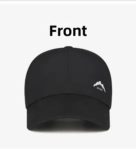 Close-up of black baseball cap featuring a white sport mountain icon and peak design