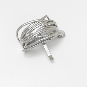 Close-up of silver irregular wire bird nest ponytail hook hair accessory in minimalist style