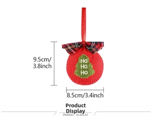 Detail of red knit Christmas ball ornament with Ho Ho Ho text and green tree patch