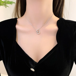 Minimalist silver interlocking double ring necklace with micro-pave crystals on model