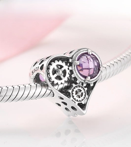 Macro shot of S925 silver mechanical heart charm with purple stone and gear details