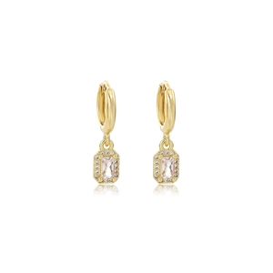 Detail of gold huggie earrings with emerald-cut crystals and a halo of small zircons