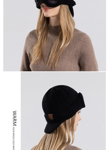 Detail of black knit winter hat featuring integrated goggles and soft fleece lining