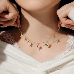 Detail of S925 silver HAPPY necklace with Christmas cane and enamel letter charms