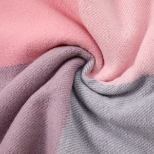 Soft pink and grey plaid winter scarf with thick knit texture and tassels for warmth