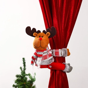 Close-up detail of festive plush reindeer Christmas curtain tieback on red velvet curtain