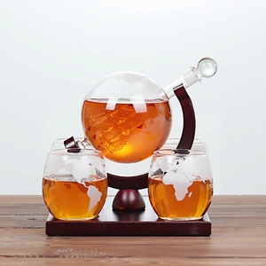 Detailed globe whiskey decanter with etched map, internal glass ship, and two glasses