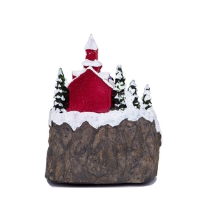 Close-up of resin Christmas snow house with red cottage and white snow details
