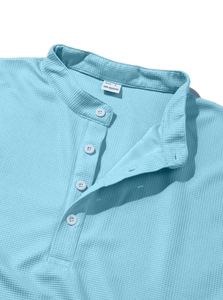 Close-up of light blue waffle texture polo shirt showing collar detail and size L label