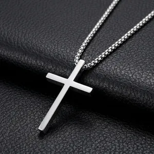 Macro shot of silver stainless steel cross pendant on a classic box chain