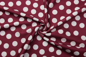 Close-up of wine red fabric with white polka dots showing soft texture and drapes