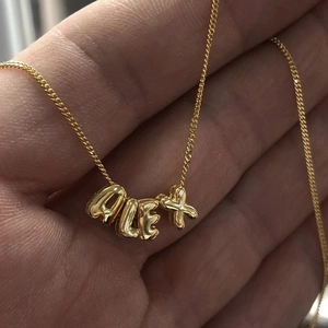 Polished 18k gold plated bubble letter necklace with ALEX initials on a fine chain