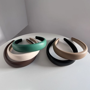 Close-up of high-quality PU leather headbands in various colors on a white table