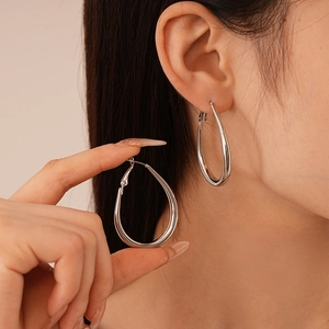 Polished silver teardrop hoop earrings for women featuring a sleek geometric design