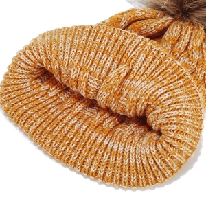 Close-up of thick rib-knit texture and orange-white mixed yarn on kids winter hat