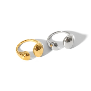 Detail of mirror polished gold and silver irregular water drop open rings on white background